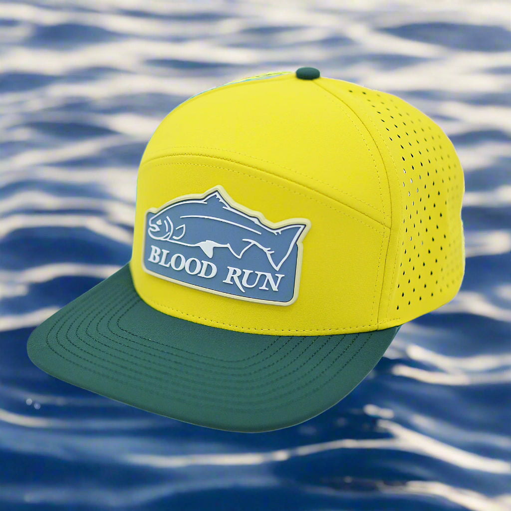 Yellow and teal cap with 'Blood Run' logo on a white background