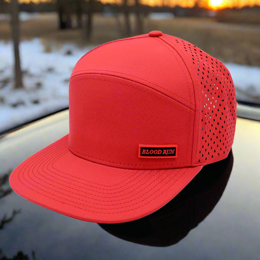 Red cap with perforated design on a white background